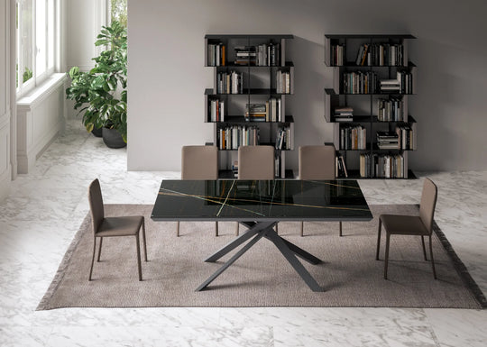 Dining room with the 4x4 black glass table and chairs in a modern interior setting.