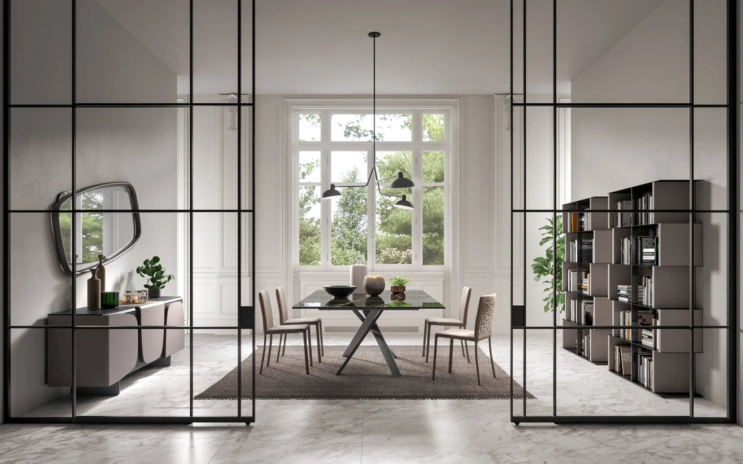 Modern interior design with glass partition, 4x4 dining table, and bookshelf.