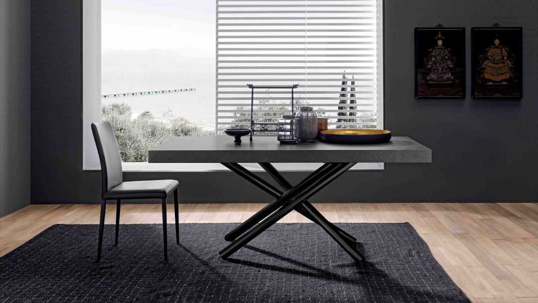 London modern dining table with black legs and a gray chair in a room with large windows.