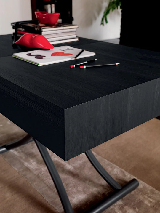 Box, black desk with stationery items on a neutral background