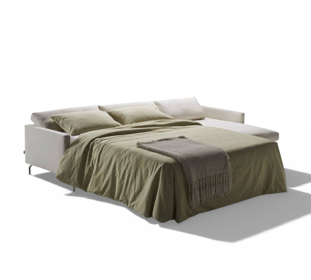 Dave Corner as a bed with green bedding and blanket on a white background