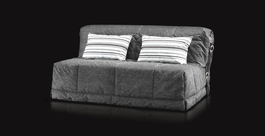 Grey Gil sofa with striped cushions on a black background