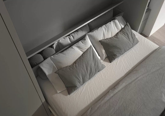Workstation wall bed with gray pillows and a headboard with storage compartments.